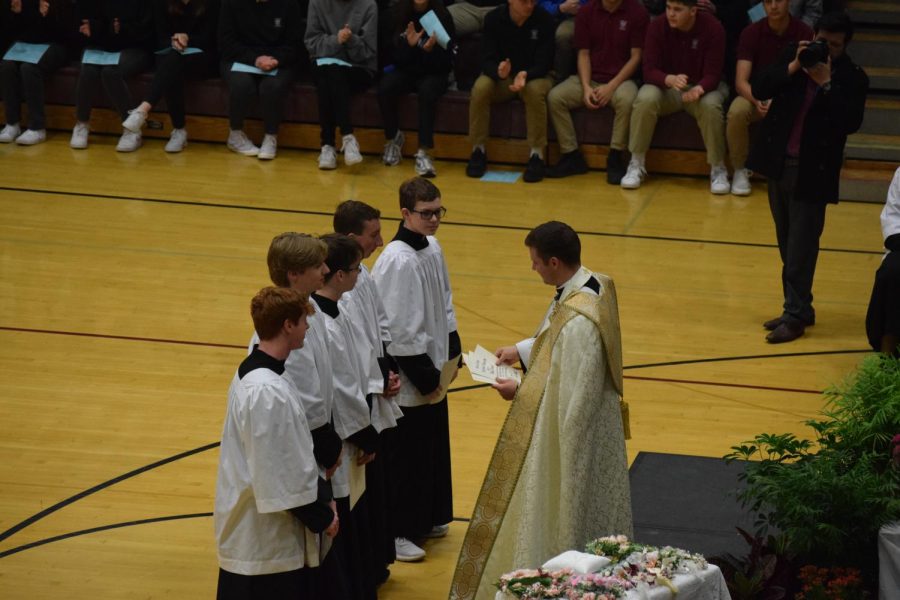 Altar servers Ben Hoover, Danny Nielsen, Luke Howard, Matthew Dietrich, and Jackson Kerkhoff receive awards for their participation in altar serving through their years at Dowling.