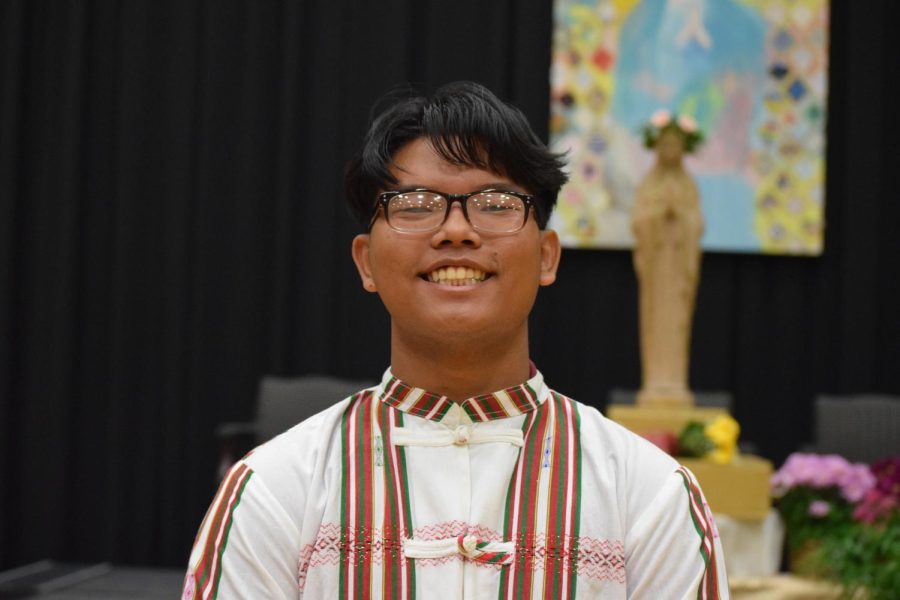 Luke Tuang smiles in front of the statue of Mary after representing Myanmar in the May Crowning ceremony.
