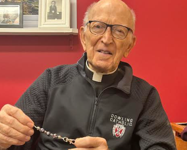 Fr. Acrea holding his special rosary of three beads. Each bead symbolizes one Hail Mary.