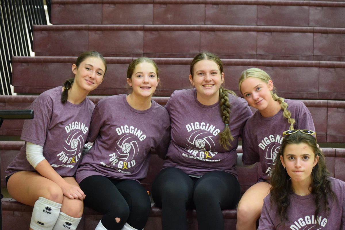Marissa McCarty, Addy Alessio, Julia Timmins, and Elly Alessio smile for the camera, showing off their Digging for Gold shirts.
