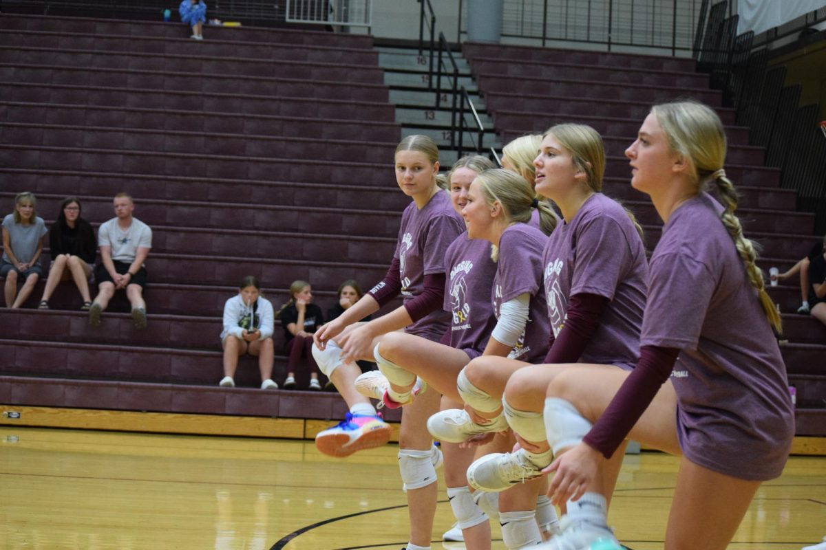 The JV volleyball girls stretch before warming up.