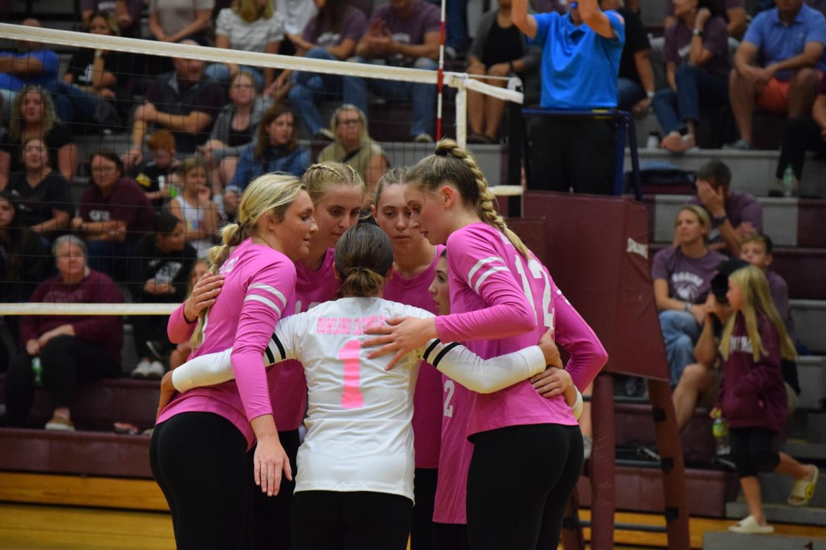 Siri Beecher, Ellie Muller, Ella Rogers, Alexis Theis, Kenzie Dean, and Anne Grant quickly huddle after a point.