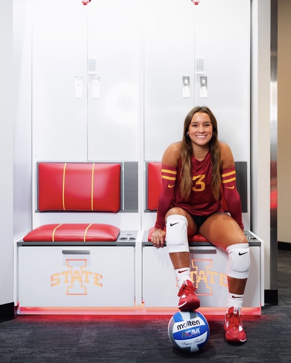 Anne Grant smiles during her commitment photoshoot, repping ISUs red and gold.