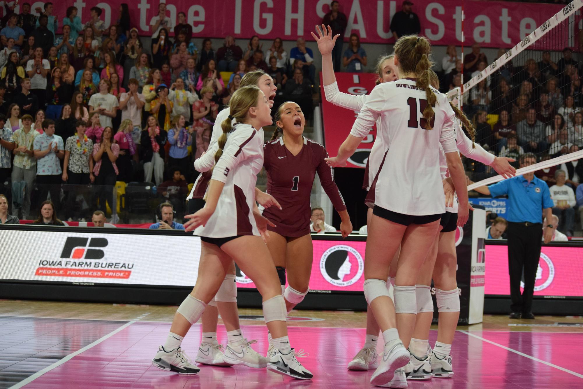 The Dowling Catholic girls volleyball team celebrates a point after a long rally.