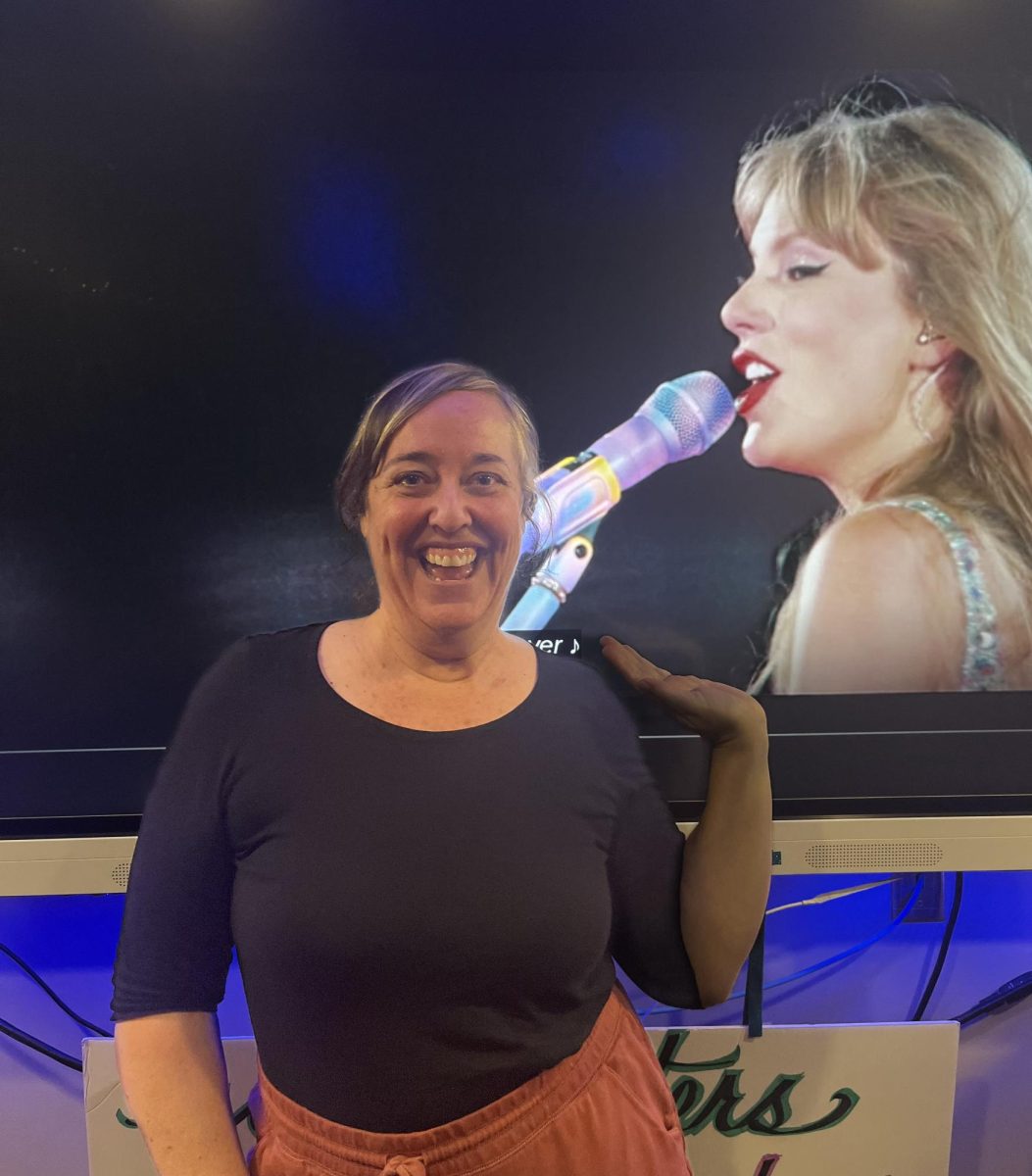Molly Pierce poses with an image of Taylor Swift, one of her favorite female artists. 