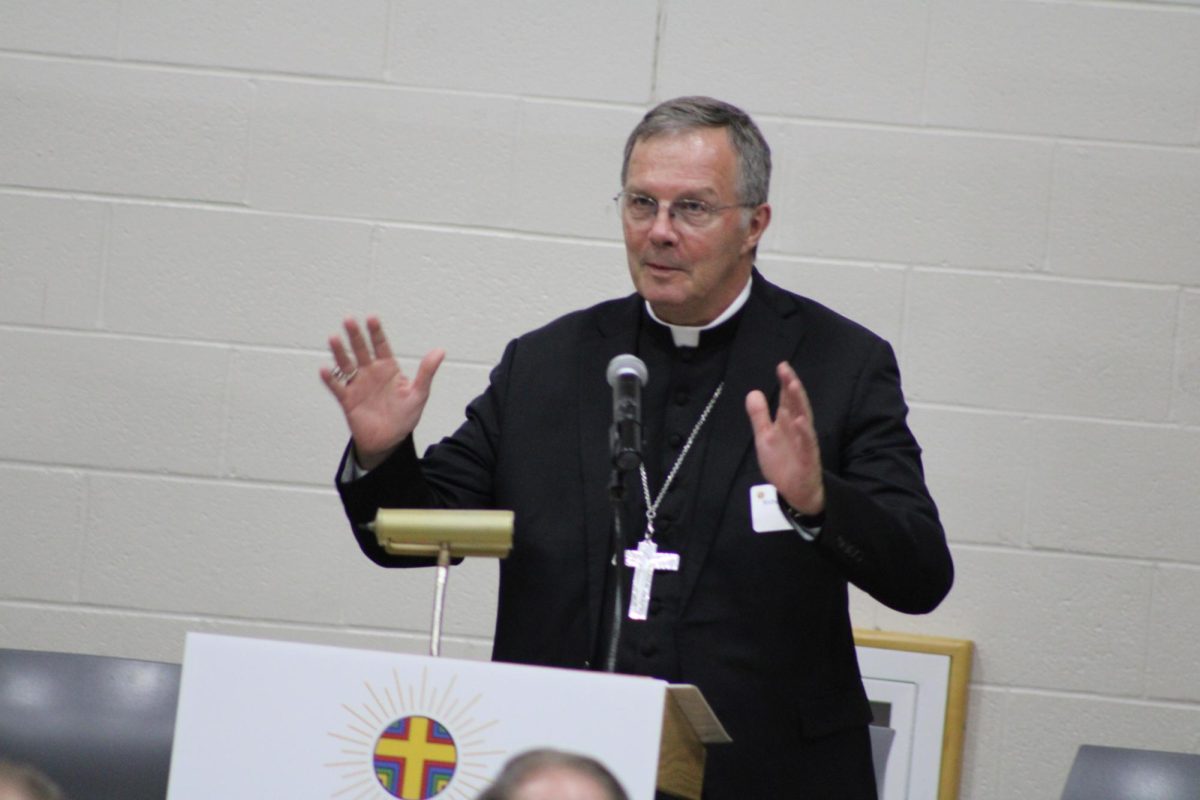 Bishop Joensen blesses the group after dinner celebrating Catholic schools.