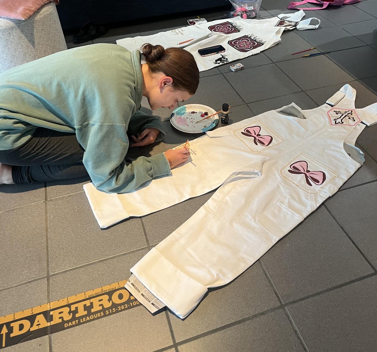 Rachel Talley works on her senior overalls.