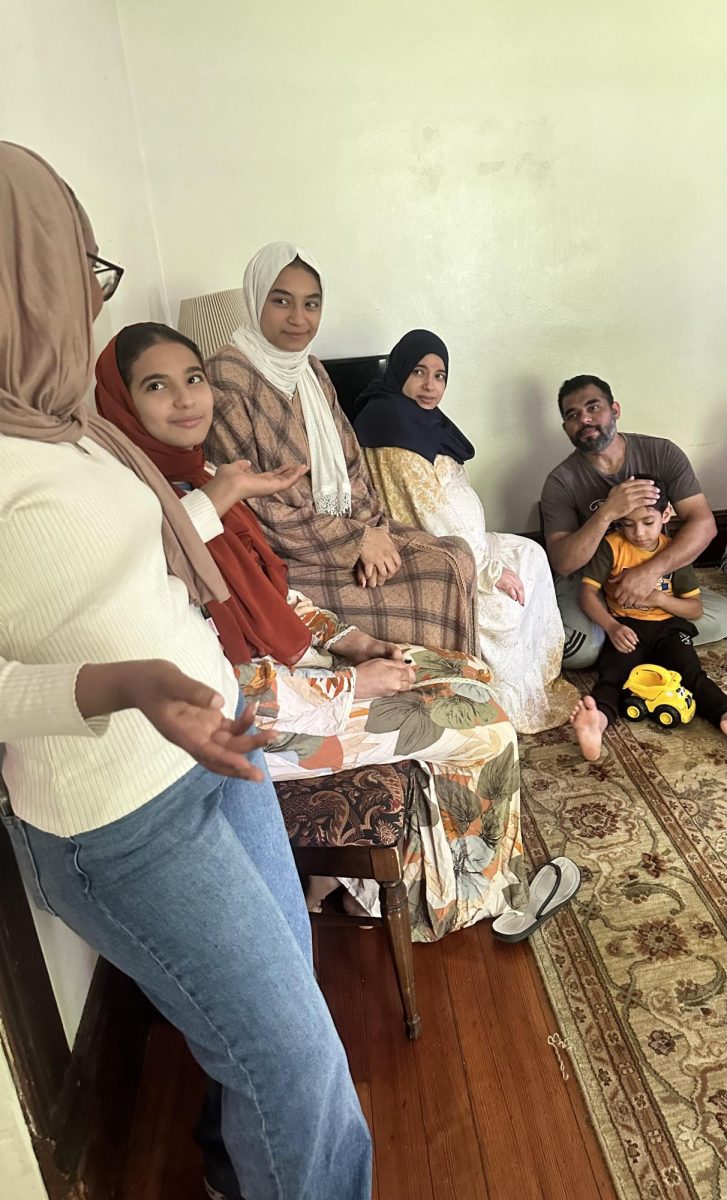 Lamyaa Shaban is joined by her family and an Arabic translator as I meet to speak with them at the Immigrant Welcome Network of Johnson County's shared house.