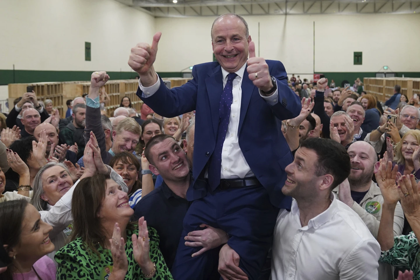 Fianna Fail leader Micheal Martin hoisted up after he won Ireland's election.