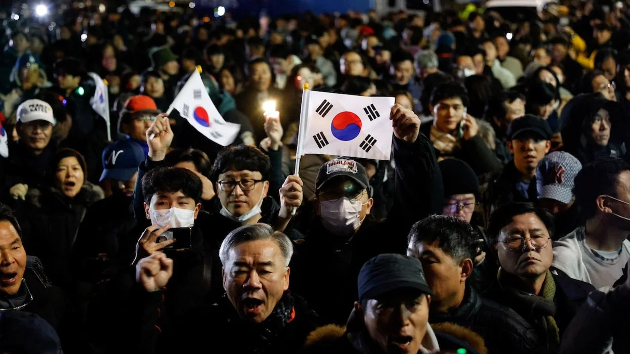 People gather outside the National Assembly after South Korean President Yoon Suk Yeol declared martial law, in Seoul, South Korea. 