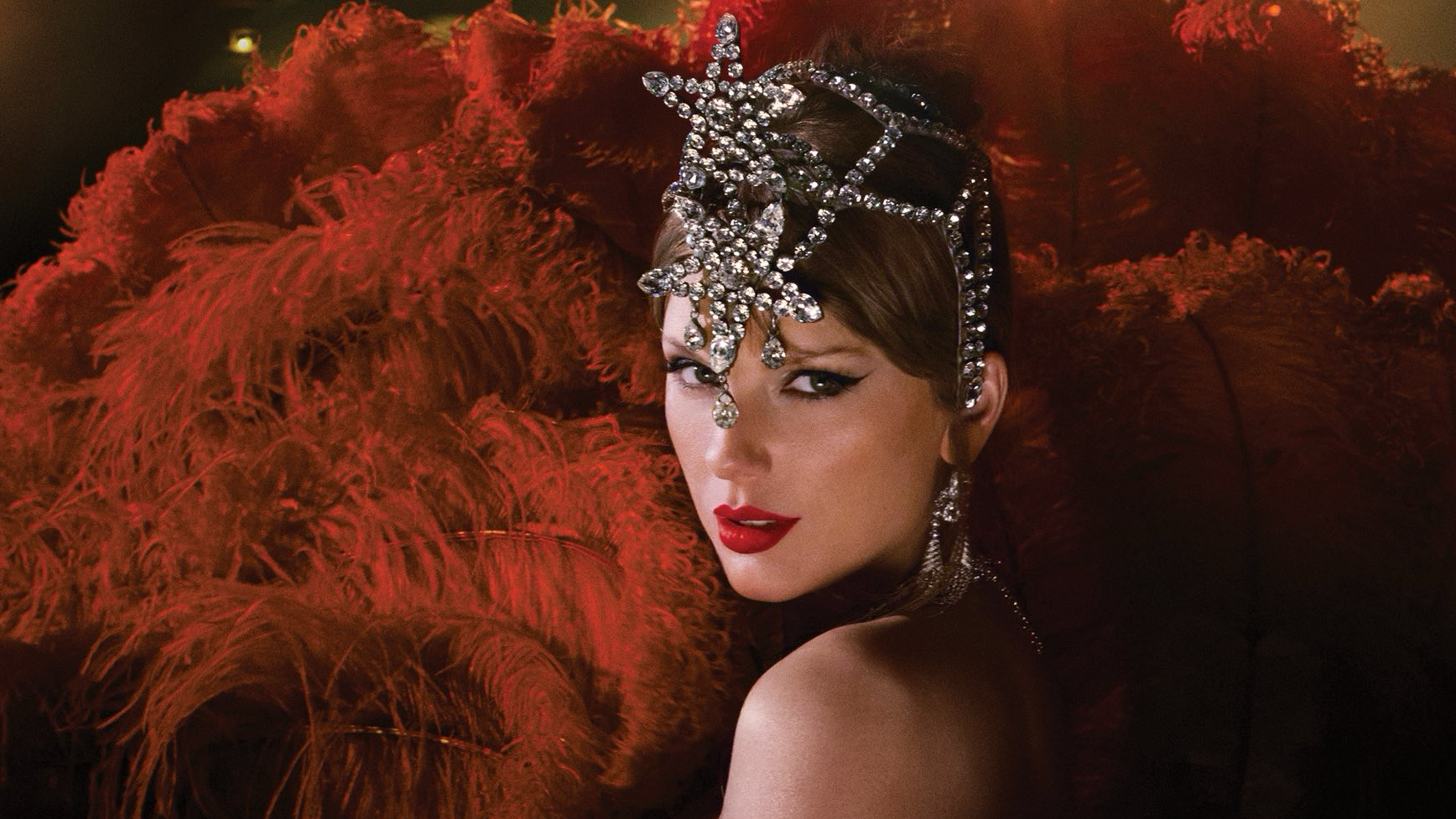 Taylor Swift posing in an elaborate outfit to promote her new album. 