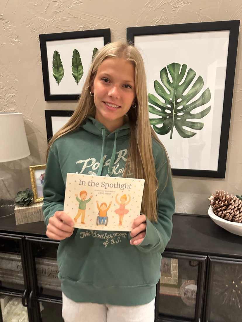 Ella Larson proudly holds her original children's story, "In the Spotlight". (E. Larson)
