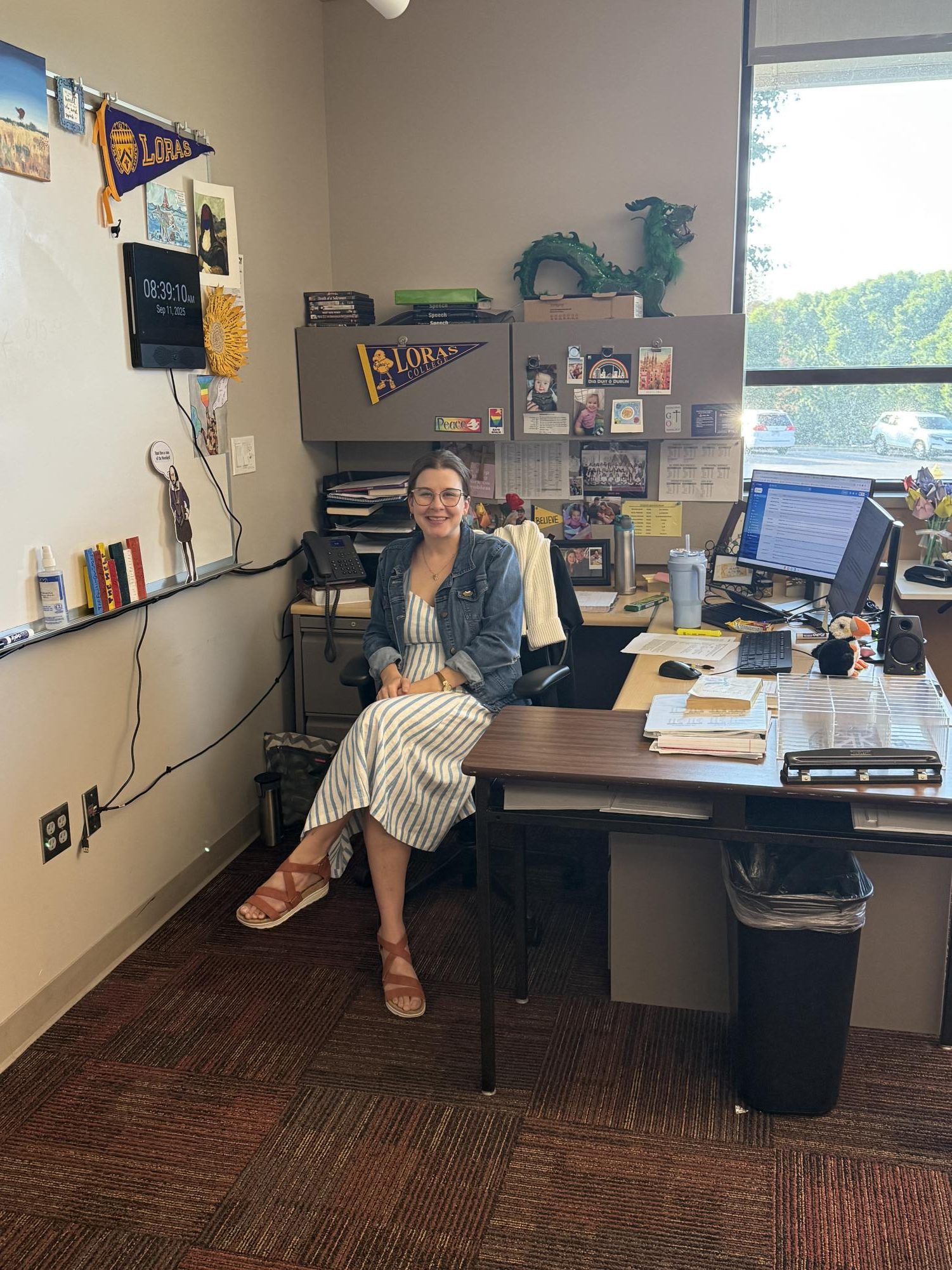 Mrs. Jurić beams from her desk in her classroom.