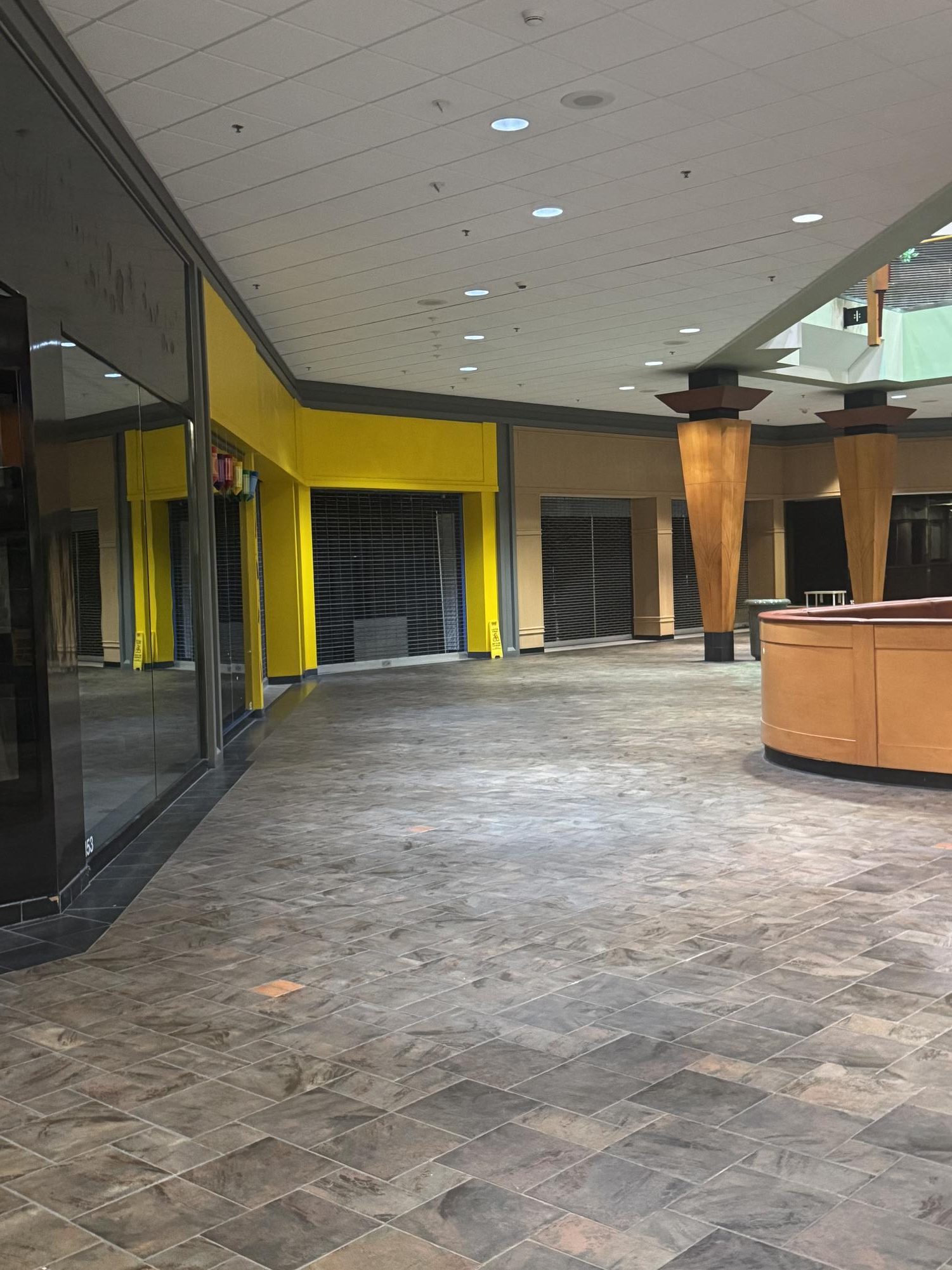 Inside of the mall, a row of unoccupied business suites. 