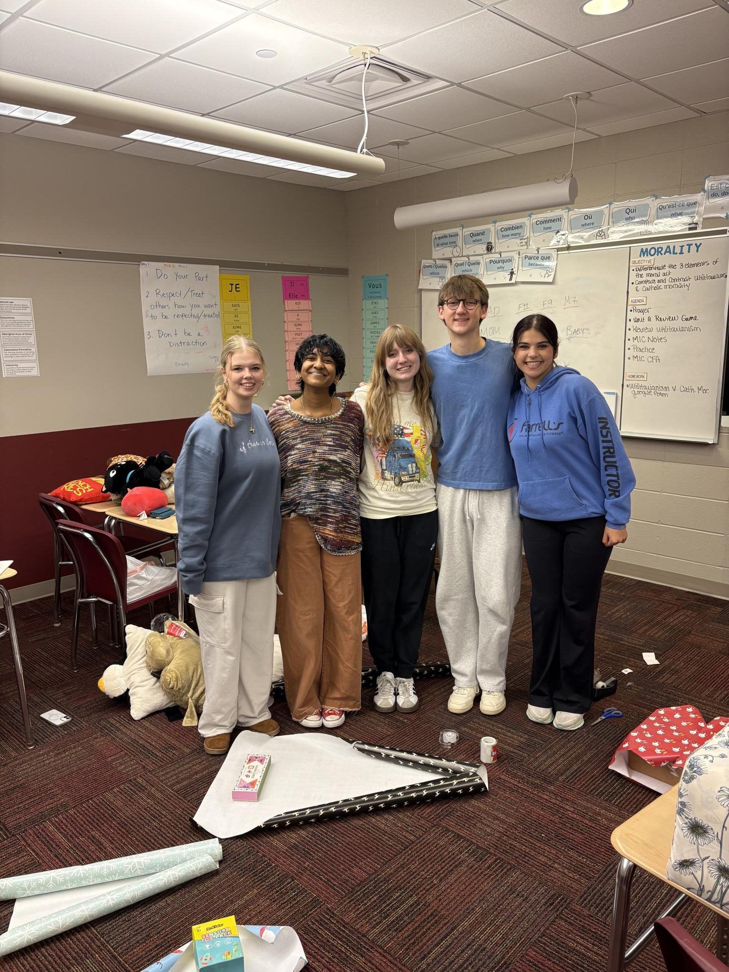 Owen Nigg and his group take a picture before continuing to wrap their gifts.