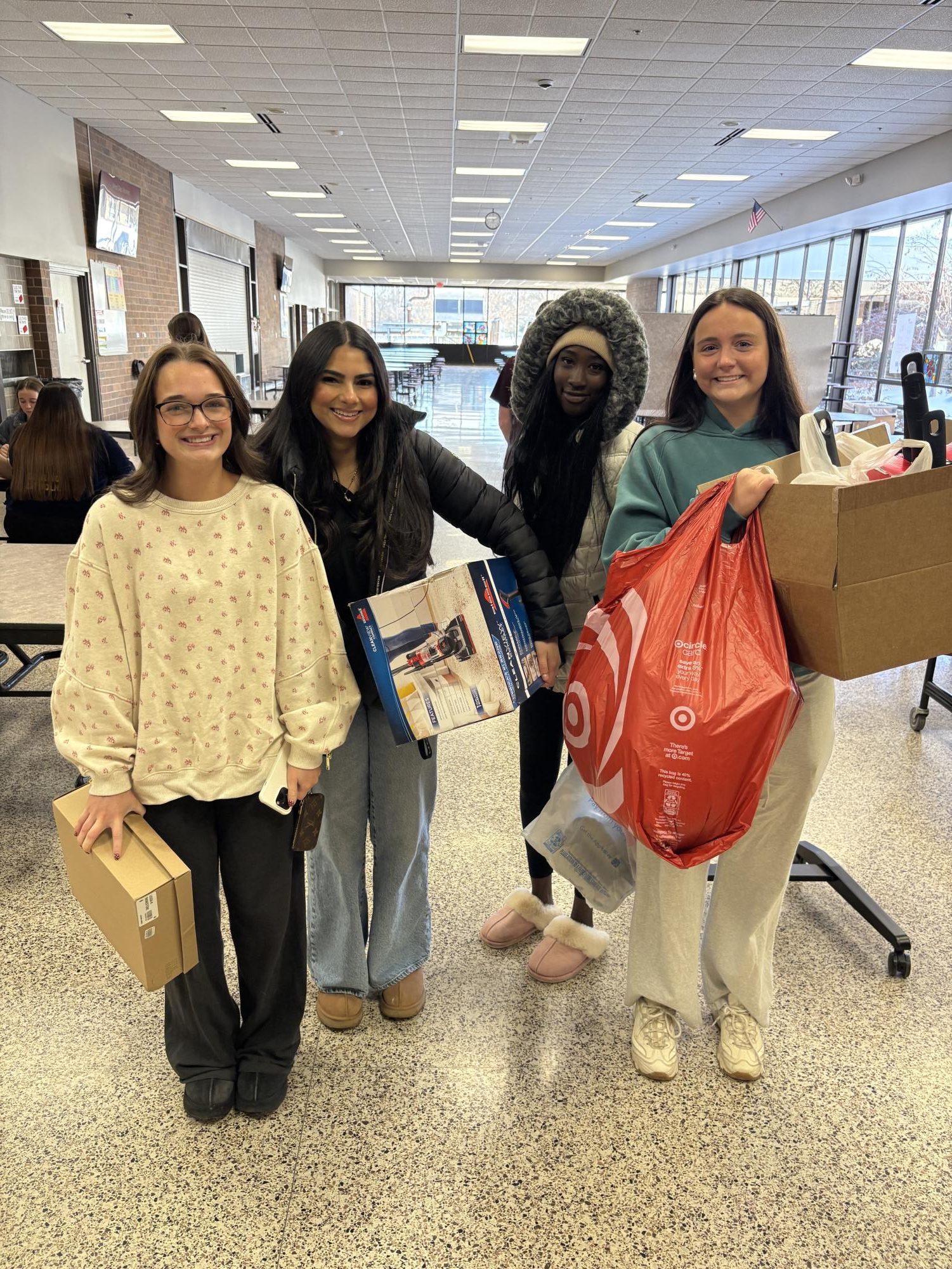 Tessa Potthoff and her group smile for a picture well holding their gifts. 