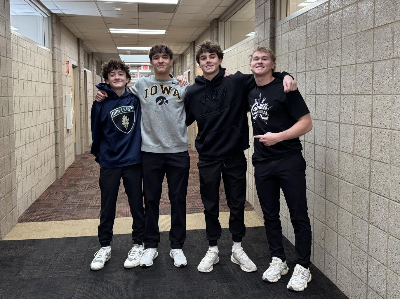 Grant Staudt, Michael Grant, Luke Logsdon, and Jackson Fleming smile for a photo.