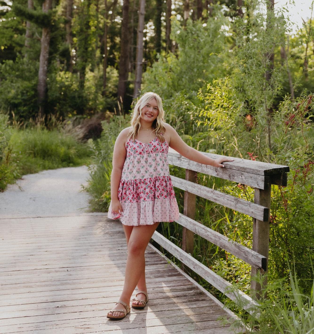 Caelin Kulnar poses for her senior photos with a smile on her face