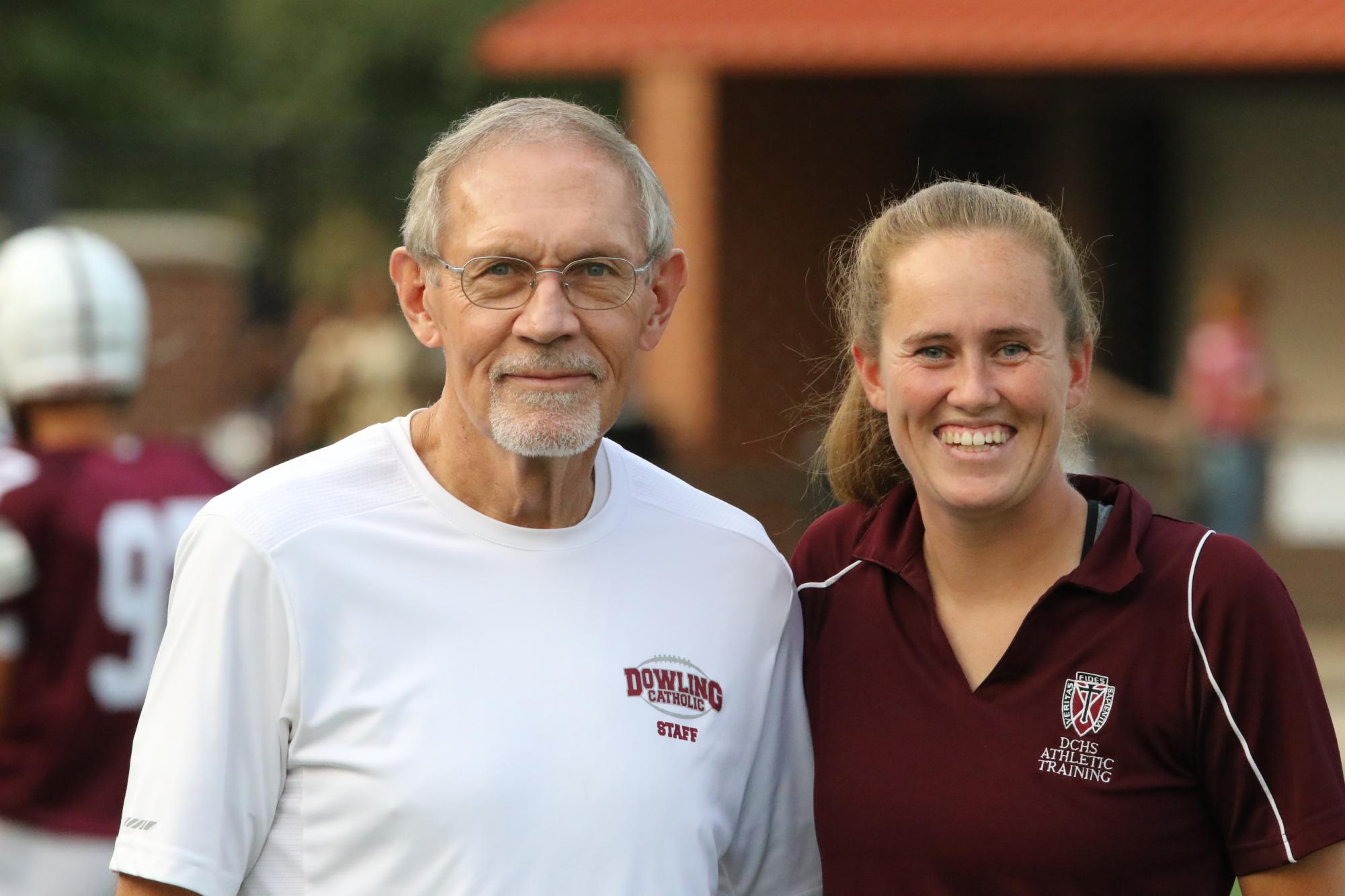 Lark and Sarah pose for a photo together at a Dowling football game.