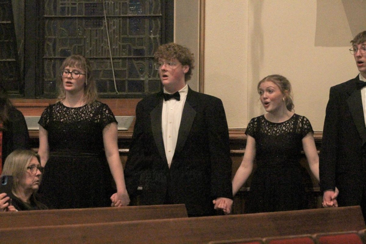 Jolenne Bigelow (11), Quentin Steinbach '26, and Jacqueline James (11) sing during a choir concert